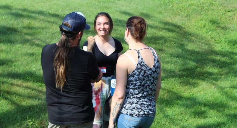Three people speak to each other at the family seminar of an outward bound intercept course